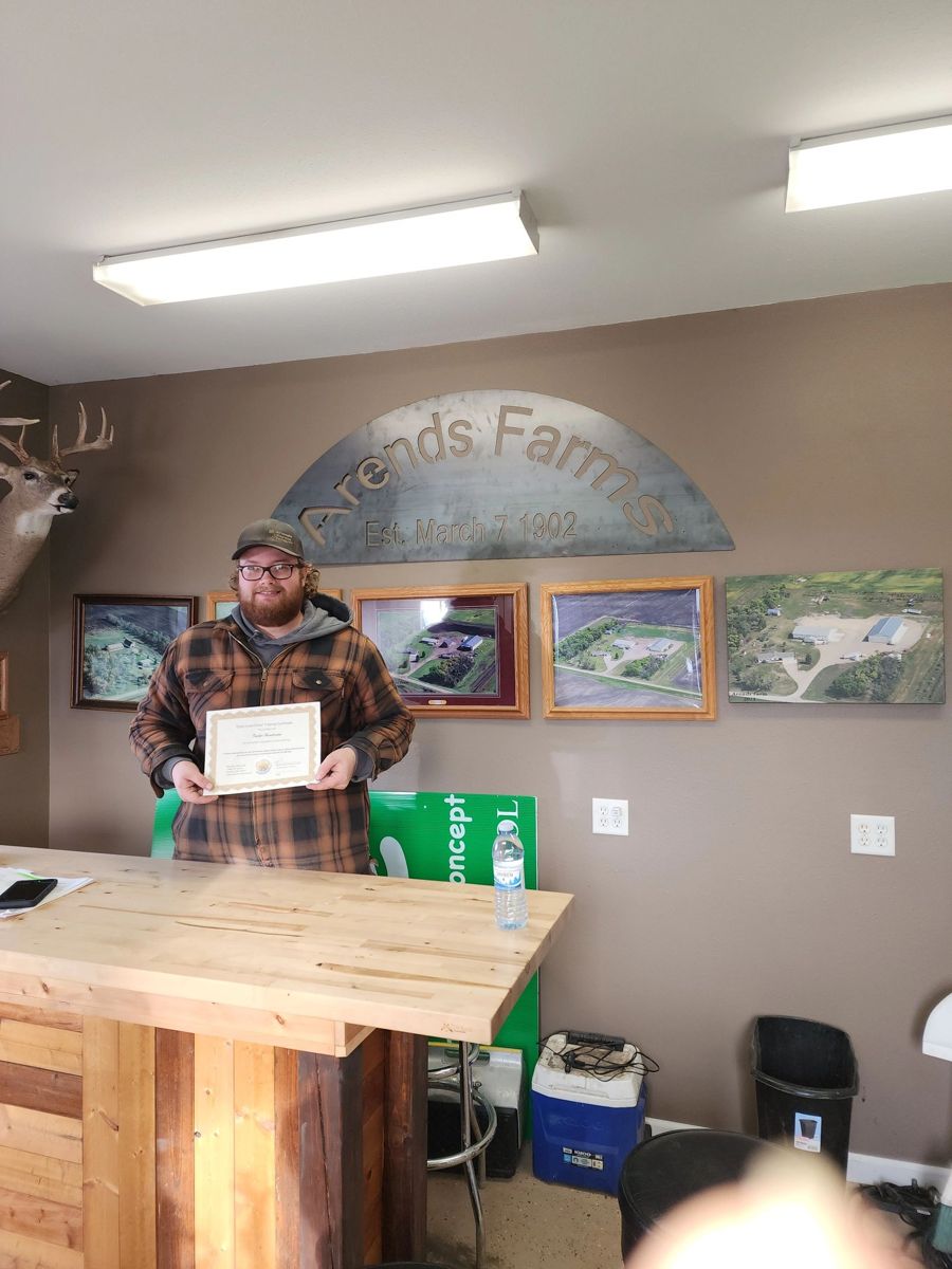 Graduate holding a training certificate